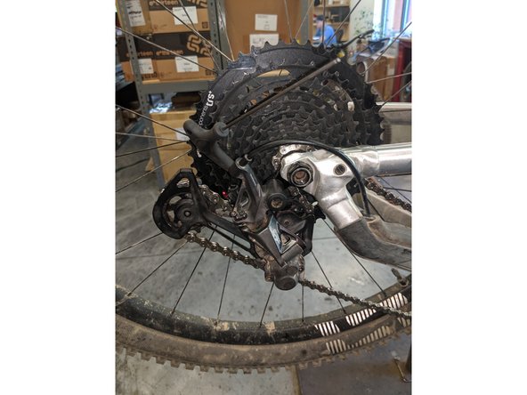 Thread the B-limit screw in until the slack is taken out of the chain by the derailleur