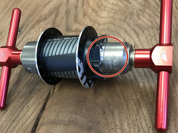 Put the handle back on the rod and tighten the tool to press the non-drive side bearing in, capturing the axle between the bearings