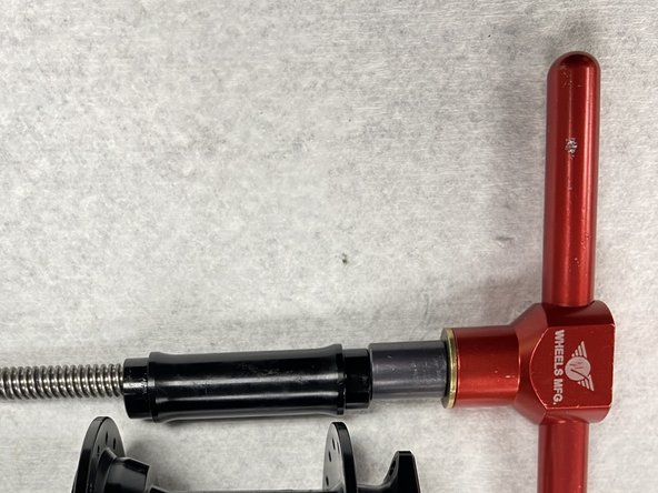 Slide the bearing drift and axle reducer onto the bearing press tool.