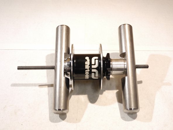 Put the handle back on the rod and tighten the tool to press the drive side bearing in, capturing the axle between the bearings