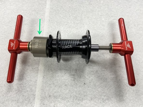Place the bearing removal cup on the disc side of the hub. This cup should be larger in diameter than the outer bearing race.