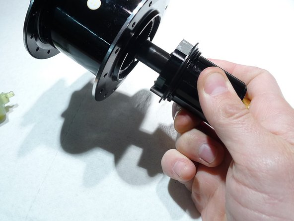 Slide the axle and freehub assembly into the hub shell