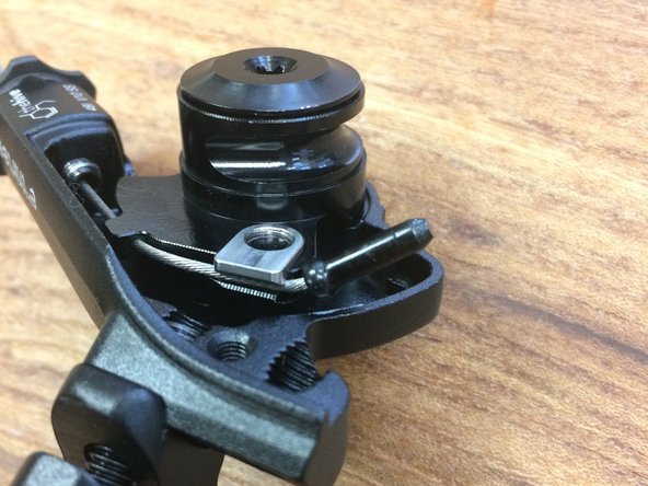 You can trim it close to the clamp or bend it down slightly and install a cable end close to the clamp (we removed the lever for a better view)