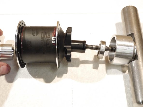 Remove the axle and bearing from the hub shell