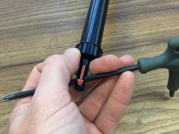 While pulling the cable tower down to release the locking mechanism, carefully slide the pillar in to the inner tube