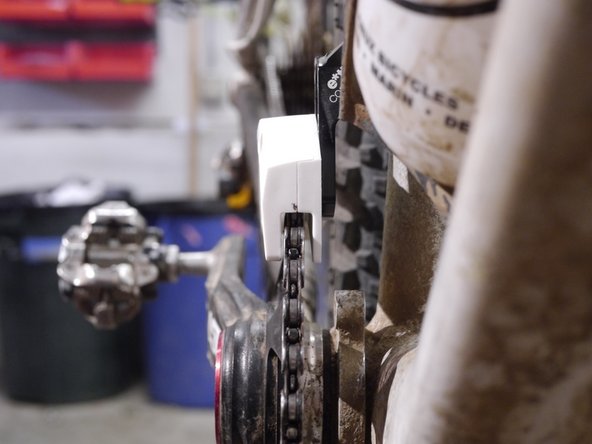 Sight down the front of the guide and chainring, adjust the slider until the seam in the slider is centered over the chainring by turning the shim-cam