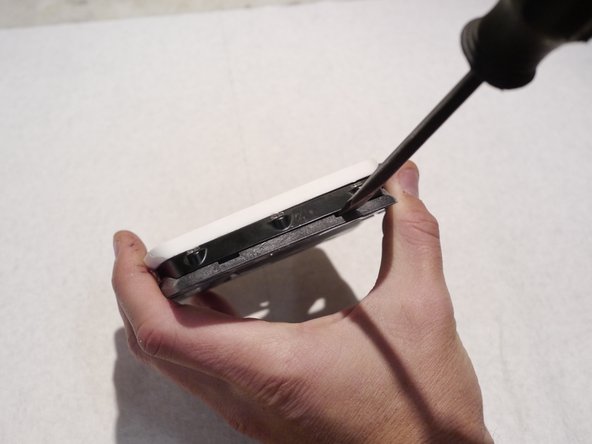 Newer pedal plastics include slots for a flat blade screw driver if you are having trouble prying the plates off