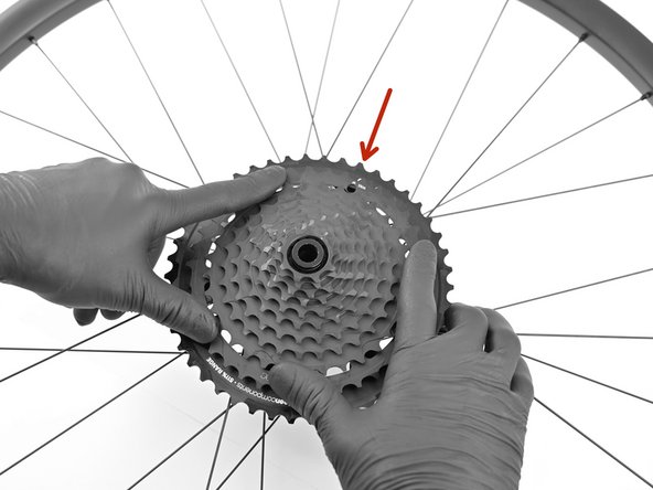 Align arrow on steel cluster with unlock symbol on alloy carrier. Apply firm, even pressure on the steel cluster so its fully seated on the XD driver and alloy cluster.