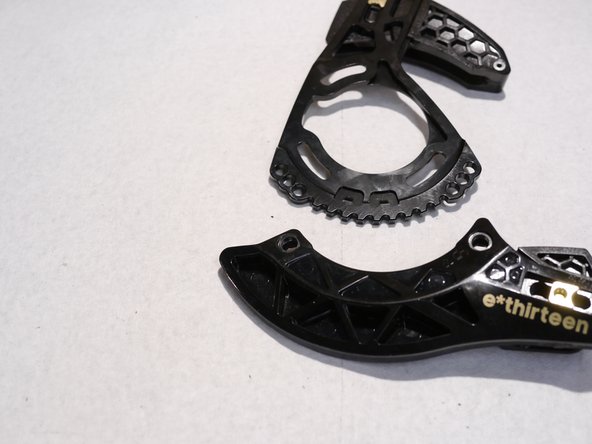 The direct mount bashguard is keyed into the back plate, to remove the direct mount bashgaurd pull firmly on the back of the bashguard