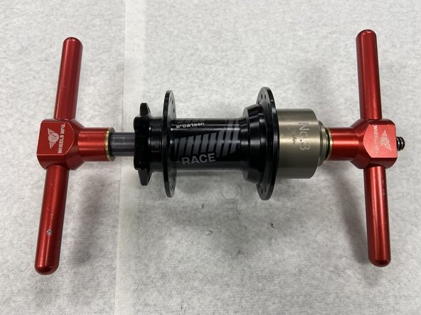 Using your bearing press, place the axle press tool on the disc side axle reducer. This will press the axle through the hub.