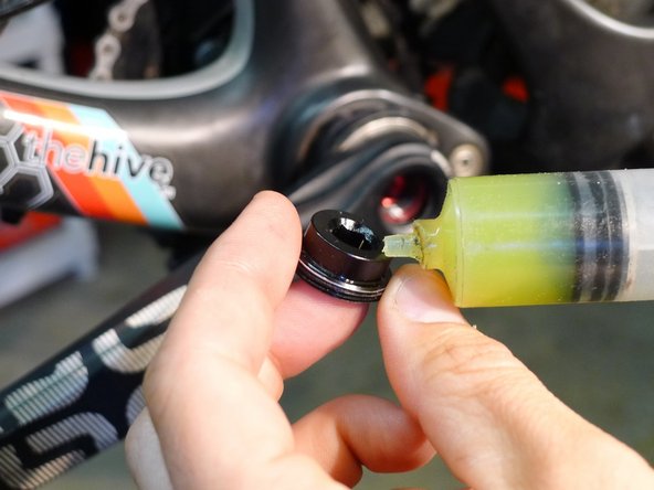 If using the Hive removal tool, grease the face of the tool and the threads