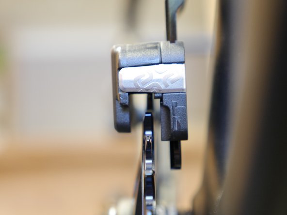 Close the upper slider and sight down the front of the guide and chainring