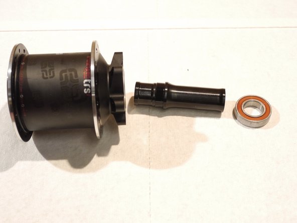 Remove the axle and bearing from the hub shell