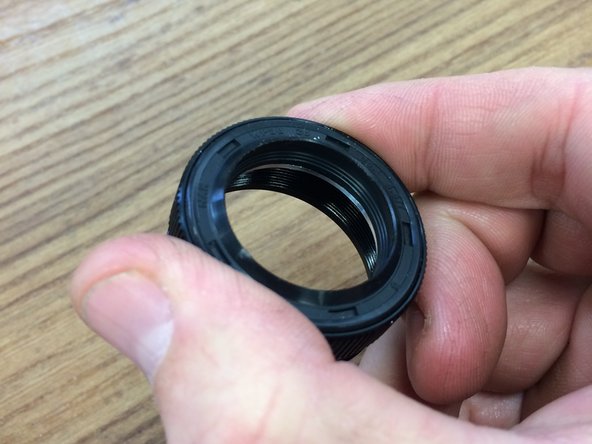 Remove the main seal from the outer tube by turning it counter-clockwise