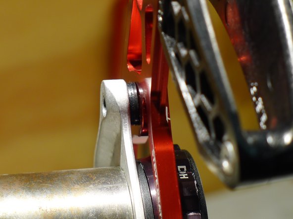 Using the provided ISCG washers between the backplate and the ISCG tabs (or adapter), position the guide such that the seam on the upper slider is centered on the chainring