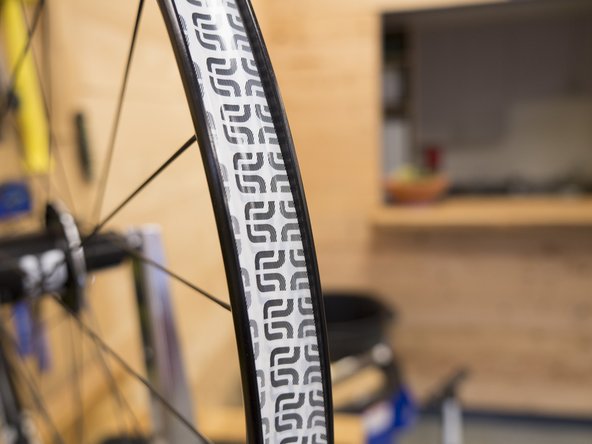 Cover the rim with two layers of tape, stop once you have passed the valve stem for the third time (this means a short area over the valve hole with have three layers of tape).