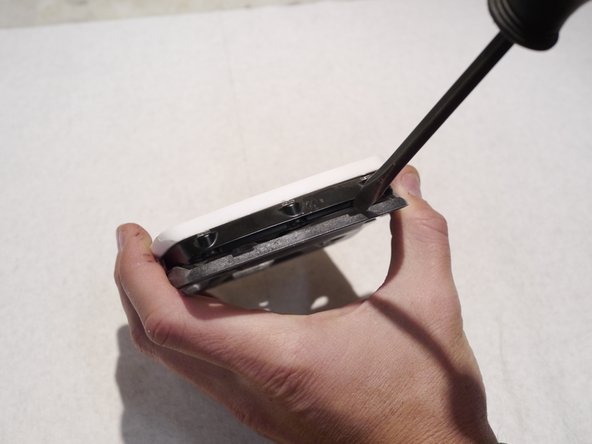 Newer pedal plastics include slots for a flat blade screw driver if you are having trouble prying the plates off