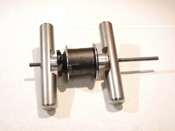 Put the handle back on the rod and tighten the tool to press the drive side bearing in, capturing the axle between the bearings