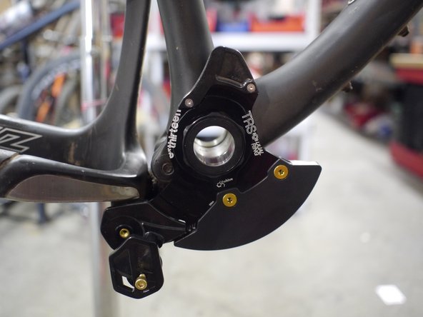 Start with the 0.5mm BB spacer mounted between the chainguide and the frame