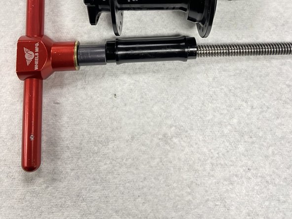 Slide the bearing drift and axle reducer onto the bearing press tool.