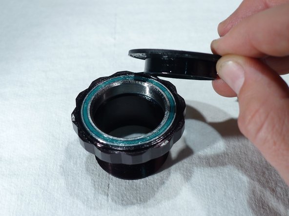 To remove the dust seal, gently slide a small flat blade screwdriver under the dust seal