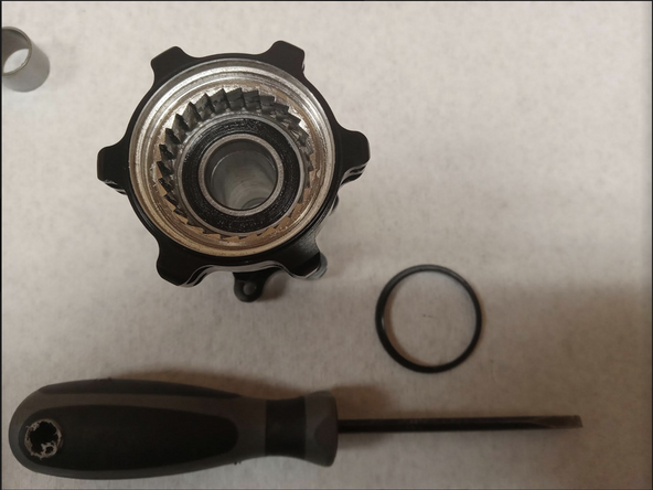 To remove the seal, gently pry the seal out from the hub using a sharp pick or flatblade screwdriver. Be careful not damage/bend the seal when removing.