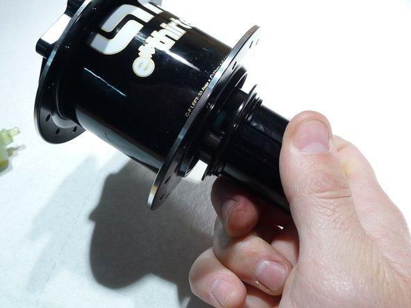 Turn freehub counterclockwise so that the pawls compress the springs and slide into the hub