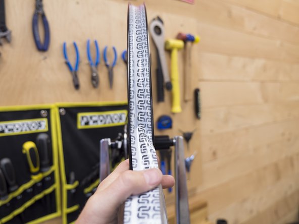 Continue taping the rim, keeping the tape tight and making sure it is centered in the rim.