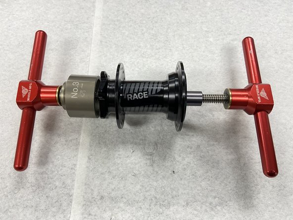 Place the bearing removal cup on the disc side of the hub. This cup should be larger in diameter than the outer bearing race.