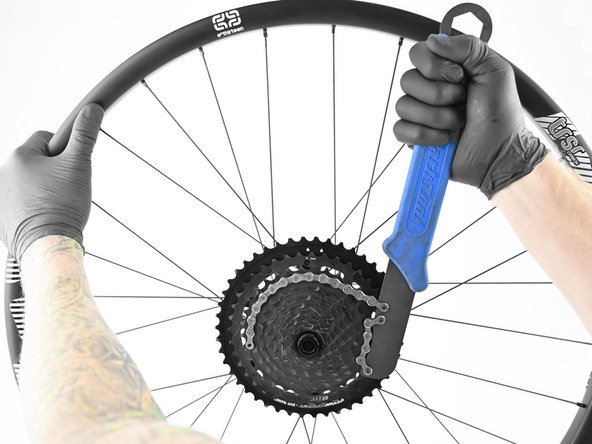 Using the chainwhip or HG lockring tool on of the steel cogs tighten clockwise to to the "locked" position.