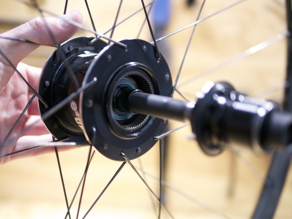Slide the axle assembly into the freehub spacer and hub shell