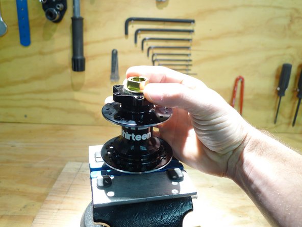 Tighten the preload adjuster by hand