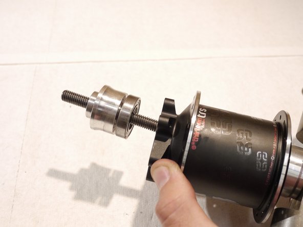 Slide the bearing over the bearing press tool