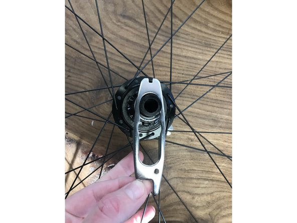 Using the provided cone wrenches, tighten the axle to snug plus 60 degrees.