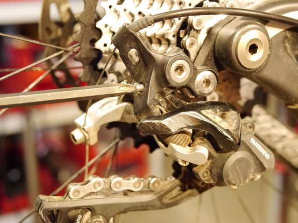 Adjust the B-limit screw so that there is a 5-6mm gap between the upper derailleur pulley teeth and the teeth on the EX cog