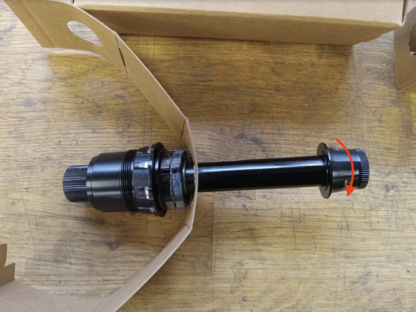 Remove the non-driveside Axle endcap  by pulling it away from the driveside hub axle while turning counter-clockwise. Hold the driveside of the axle in place while loosening the endcap.