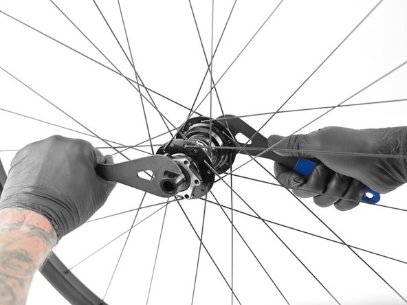 To remove the axle place the 17mm cone wrench on the drive side axle flats and 18mm cone wrench on the non-drive endcap and turn counter clockwise.