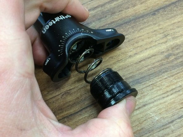 Lightly grease each end of the spring and install the spring in to the post