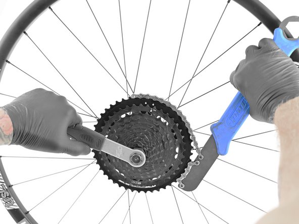 Place the chainwhip on the single largest alloy cog. Install cassette lockring tool into end of steel cluster.