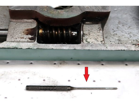 Use a 3/32 punch to remove 3/15 roll pin in speed change gear.