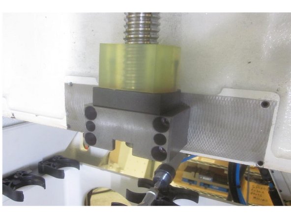 Install the Z axis lower cushion and spacer to the bearing housing. Install the Z axis ball screw cover starting the bottom vertical screws first. Tighten all screws securely then jog the axis and check for binding or misalignment. Adjust as necessary.