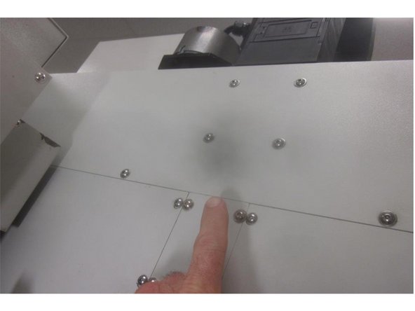 Install the Z axis brake cover. Install the spacer and cushion on the lower bearing housing. Install the Z axis ball screw cover. Lube all fasteners. Start the bottom screws in the lower bearing housing then start the rest. Starting at the top working down, tighten all the screws securely. Install the ATC door.