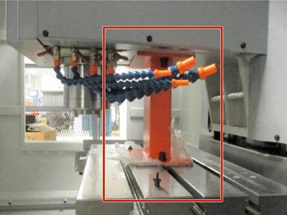 Place foam and/ or  wood to protect the table. Center the X and Y axis and raise the Z-axis up giving clearance to place the head support underneath as shown. Lower the Z-axis to the head support. Press the E-stop and turn off power to the machine.