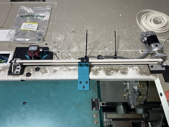Open the door all the way and install Bando belt tension meter at the center of the belt travel. Adjust the tension to 50Hz +\- 3Hz. If you cannot get the belt tension to 50Hz you may need to shorten the belt 1 or 2 teeth.