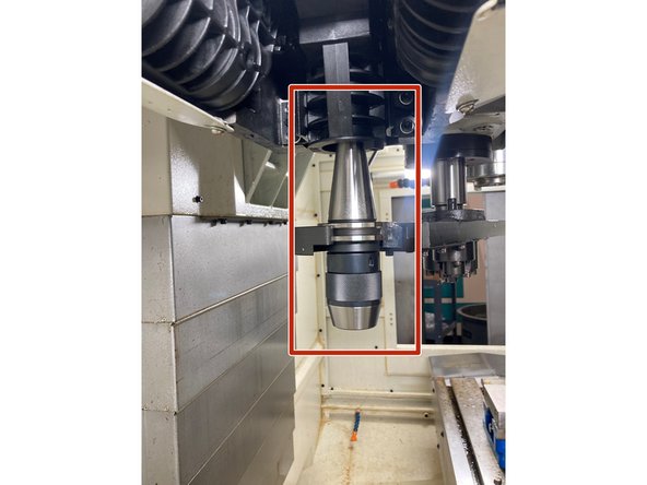 If the Tool remains in the ATC arm, move the arm to a safe location by pressing [Arm] and tapping [+] or [-].