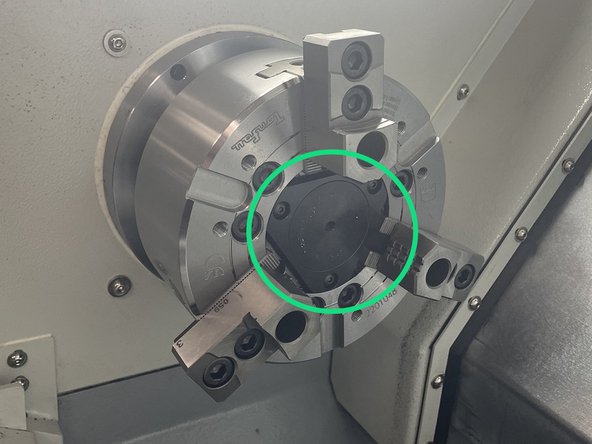 Reinstall one of the chuck jaws to hold the spindle while torquing the chuck to 58ft-lbs.