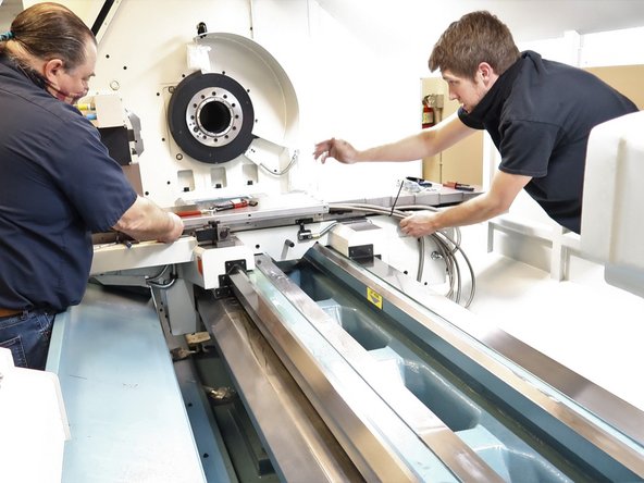 Route the hoses near the table in the lower cross slide. The five hoses and one electric line will fit in the cross slide with the top bolted in place. Use rubber hose clamps to control the hoses from the cable carrier up to the table.