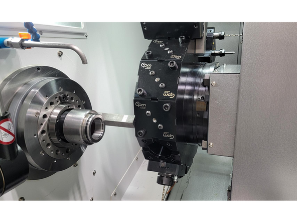 Place a precision gauge block (6.000" or longer) firmly against the main spindle face.