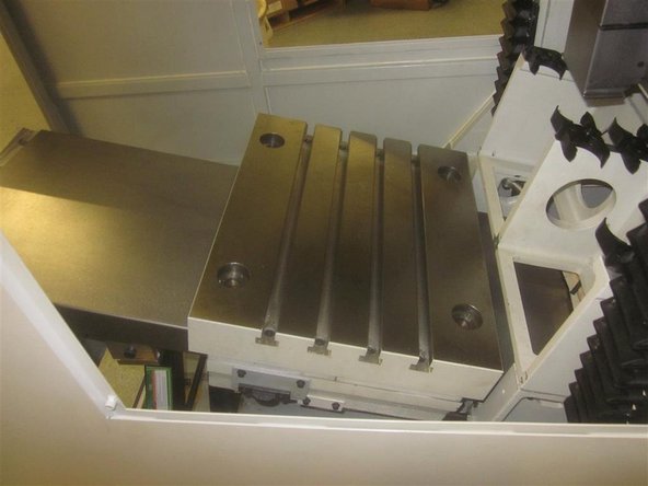 Remove the plastic block (temporarily), and look for shims placed between the rear of the bridge and the ground spacer.