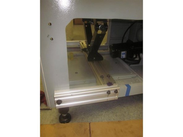 Place the 1 1/2 x 3 x 30 1/4 aluminum frame piece and rest it on the machine casting with the short square pieces facing down (shown on the image). Attach the side supports. Install the jack to the main frame. Attach the main &quot;U&quot; support to the top of the jack. Leave all fasteners slightly loose for minor adjustments.